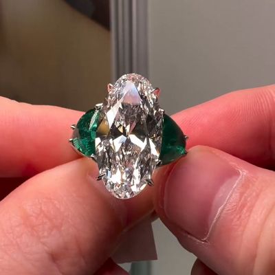 10ct Oval Cut White Sapphire Flanked By 2 Emeralds Three Stone Engagement Ring